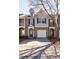 Traditional brick townhome boasts a one car garage, blue shutters and tidy landscaping at 2873 Snapfinger Mnr, Decatur, GA 30035