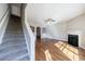 Carpeted stairs and hardwood floors meet in a spacious living area with a fireplace at 2873 Snapfinger Mnr, Decatur, GA 30035