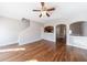 Spacious living area with hardwood floors, a view of the stairs, and an open view of the kitchen at 2873 Snapfinger Mnr, Decatur, GA 30035