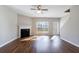 Bright living room showcasing hardwood floors, a fireplace, and ample natural light from a window at 2873 Snapfinger Mnr, Decatur, GA 30035