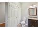 Small bathroom with tile floor, toilet, and vanity with sink at 11302 Musette Cir, Alpharetta, GA 30009