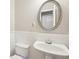 A clean half bathroom with white paneled walls at 11302 Musette Cir, Alpharetta, GA 30009