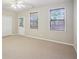 This bedroom has carpet and large windows that let in lots of light at 11302 Musette Cir, Alpharetta, GA 30009