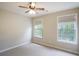 This bedroom has carpet, two windows, and a ceiling fan at 11302 Musette Cir, Alpharetta, GA 30009
