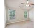 A well lit empty bedroom with a ceiling fan at 11302 Musette Cir, Alpharetta, GA 30009