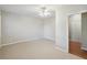 Neutral bedroom features carpet and adjoining doorway at 11302 Musette Cir, Alpharetta, GA 30009