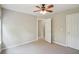 This bedroom has neutral walls, carpet, and a ceiling fan at 11302 Musette Cir, Alpharetta, GA 30009