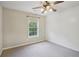 A well-lit bedroom with a large window and neutral carpet at 11302 Musette Cir, Alpharetta, GA 30009