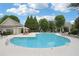 Well-maintained community pool area with lounge chairs and shade umbrellas at 11302 Musette Cir, Alpharetta, GA 30009
