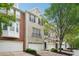 Charming townhome with well-manicured landscaping, attached garage and brick and painted facade at 11302 Musette Cir, Alpharetta, GA 30009