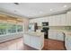 Beautiful kitchen with island, stainless steel appliances, wood floors and great natural light at 11302 Musette Cir, Alpharetta, GA 30009