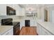 Bright kitchen features white cabinetry, stone countertops, and modern appliances at 11302 Musette Cir, Alpharetta, GA 30009