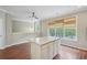 A well lit kitchen island with wooden floors and modern cabinets at 11302 Musette Cir, Alpharetta, GA 30009