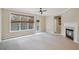 Cozy living room offering fireplace, neutral color palette and access to the backyard area at 11302 Musette Cir, Alpharetta, GA 30009