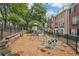 Community playground with play structure surrounded by a wood chip ground cover at 11302 Musette Cir, Alpharetta, GA 30009