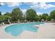 Large community swimming pool surrounded by lounge chairs and lush landscaping at 11302 Musette Cir, Alpharetta, GA 30009