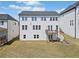 Two-story home featuring a well-maintained backyard with a small deck and walkout basement access at 117 Villanueva Rd, Woodstock, GA 30188