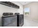 Well-lit laundry room with modern appliances and storage solutions for efficient organization at 117 Villanueva Rd, Woodstock, GA 30188