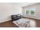 Bright living room with hardwood floors, and a comfortable sofa, perfect for relaxing and entertaining at 117 Villanueva Rd, Woodstock, GA 30188