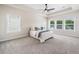 Serene main bedroom featuring natural light, a ceiling fan, and plush carpeting at 117 Villanueva Rd, Woodstock, GA 30188
