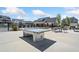 Community recreation area with a ping pong table, chairs and tables for residents to gather and play at 117 Villanueva Rd, Woodstock, GA 30188