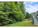 Lush, green backyard with mature trees and stairway leading to the upper level at 2311 Sims Ne Dr, Marietta, GA 30066