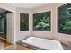 Bathroom with a luxurious tub with granite surround, natural light, and beautiful wooded views from multiple windows at 2311 Sims Ne Dr, Marietta, GA 30066