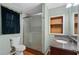 Bathroom featuring granite countertop, shower, and shelving, providing style and convenience at 2311 Sims Ne Dr, Marietta, GA 30066