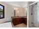 Bathroom featuring granite counters, tile shower with glass doors, modern fixtures, and natural light from the window at 2311 Sims Ne Dr, Marietta, GA 30066