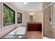 Bright bathroom with granite counters, large tub, walk-in shower, and a view of trees through the windows at 2311 Sims Ne Dr, Marietta, GA 30066