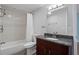 Bathroom featuring granite countertop vanity, tiled shower with a bathtub, and ample lighting at 2311 Sims Ne Dr, Marietta, GA 30066