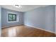 Cozy bedroom with hardwood floors and a large window showcasing the outdoors at 2311 Sims Ne Dr, Marietta, GA 30066