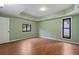 Spacious bedroom showcasing tray ceilings, warm colors, hardwood floors, and large windows with natural light at 2311 Sims Ne Dr, Marietta, GA 30066