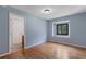 Bedroom with hardwood floors, view of the ensuite, and large window offering natural light at 2311 Sims Ne Dr, Marietta, GA 30066
