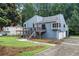 View of two-story home with a wooden pergola, lawn and driveway at 2311 Sims Ne Dr, Marietta, GA 30066