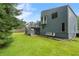 Exterior view of a blue home with a walkout basement and multi-level deck and spacious yard at 2311 Sims Ne Dr, Marietta, GA 30066