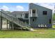 Exterior view of a blue home with a walkout basement, multi-level deck and spacious yard at 2311 Sims Ne Dr, Marietta, GA 30066