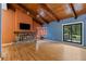 Cozy living room with a stone fireplace, wood-beamed ceiling, and abundant natural light at 2311 Sims Ne Dr, Marietta, GA 30066