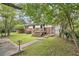 Charming backyard with a well-maintained lawn, mature trees, and a welcoming entrance at 2785 Toney Dr, Decatur, GA 30032