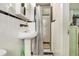 Cozy bathroom featuring a pedestal sink and tiled shower with black trim at 2785 Toney Dr, Decatur, GA 30032