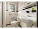 Bathroom featuring a pedestal sink, toilet, white tile, and a window at 2785 Toney Dr, Decatur, GA 30032