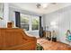 Bedroom showcasing wood floors, windows, and desk with musical instruments at 2785 Toney Dr, Decatur, GA 30032