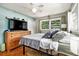 Inviting bedroom with hardwood floors, soft lighting, dresser, and ceiling fan at 2785 Toney Dr, Decatur, GA 30032