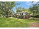 Inviting home with manicured front lawn, brick accents, and mature trees providing shade at 2785 Toney Dr, Decatur, GA 30032