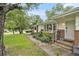 Inviting entryway with walkway, brick accents, garden bed, and covered porch at 2785 Toney Dr, Decatur, GA 30032