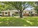 Charming home featuring a well-manicured lawn and a classic brick and white exterior at 2785 Toney Dr, Decatur, GA 30032