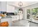 Well-lit kitchen with granite countertops, white cabinetry, stainless appliances, and sliding doors to the backyard at 2785 Toney Dr, Decatur, GA 30032