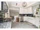 Bright kitchen with gray tile floor, white cabinets, stainless dishwasher and granite countertops at 2785 Toney Dr, Decatur, GA 30032