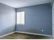 Neutral bedroom with wood floors, a window with blinds, and a view of the outdoor space at 3575 Oakvale Rd # 305, Decatur, GA 30034