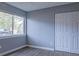 Bedroom featuring wood floors, neutral walls, a closet, and a window offering natural light at 3575 Oakvale Rd # 305, Decatur, GA 30034